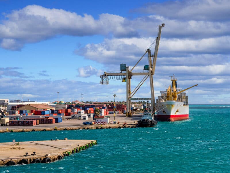 Unloading cargo vessel to the port of Oranjestad