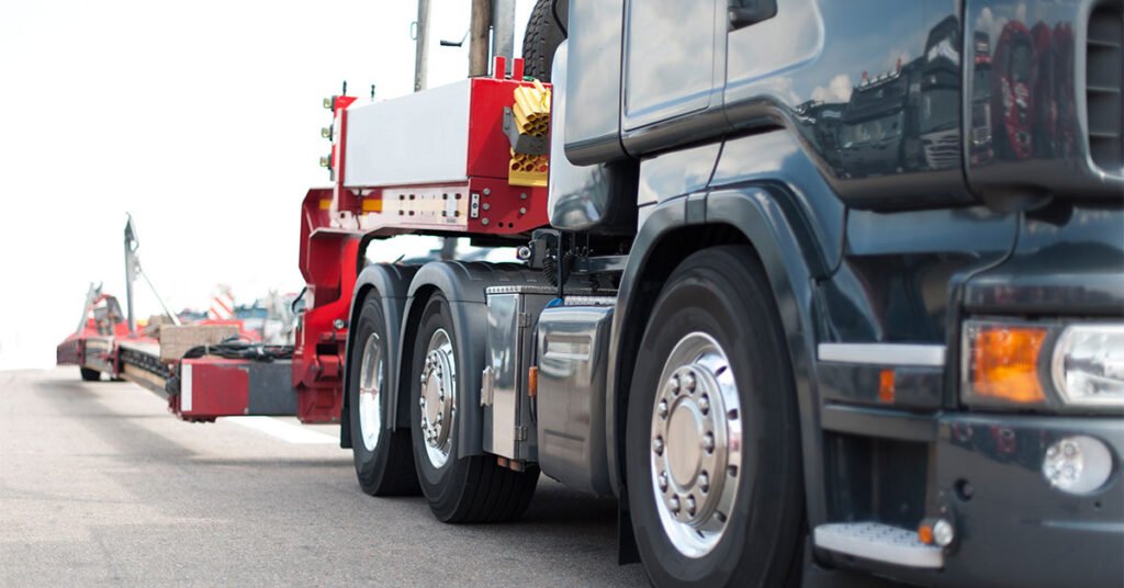Heavy haul truck transporting oversized equipment on a lowboy trailer.