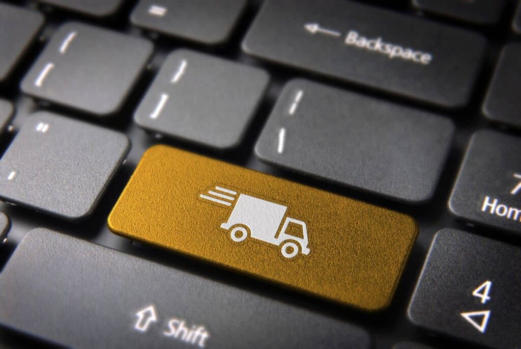 Delivery truck icon highlighted on a gold keyboard enter key.