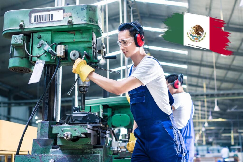 Factory worker operating drill press machinery beside a Mexican flag graphic.